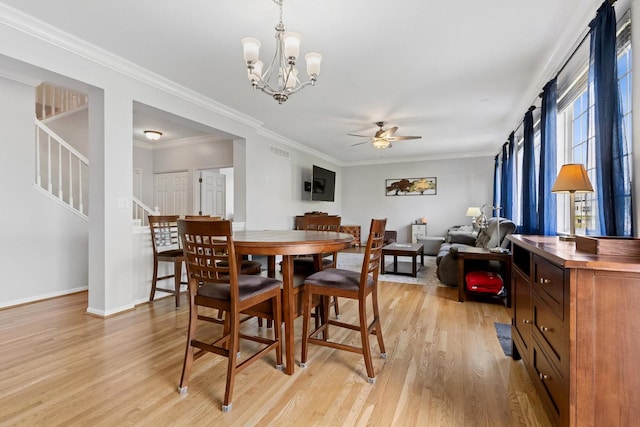 1000 Salvia Ln, Joliet, IL 60431 - dining area with stairs, light wood finished floors, visible vents, and ceiling fan with notable chandelier