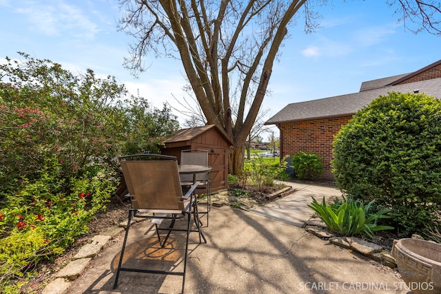 view of patio / terrace featuring a shed, an outbuilding, and outdoor dining space