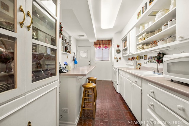 bar with a sink, dark floors, baseboards, and white appliances