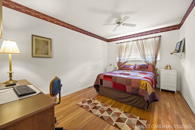 bedroom featuring a ceiling fan, baseboards, and hardwood / wood-style floors