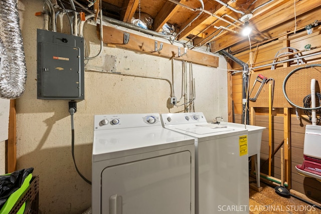 washroom featuring washer and dryer, electric panel, and laundry area