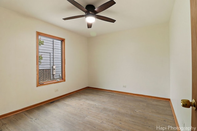 404 Rand Rd, Lakemoor, IL 60050 - unfurnished room with visible vents, a ceiling fan, baseboards, and wood finished floors