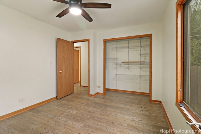 404 Rand Rd, Lakemoor, IL 60050 - unfurnished bedroom with a ceiling fan, baseboards, wood finished floors, and a closet