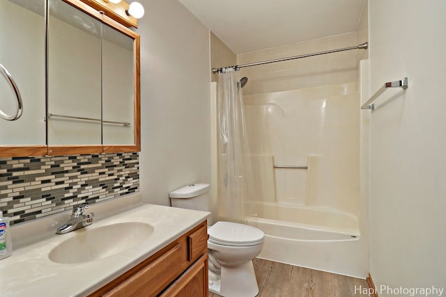 404 Rand Rd, Lakemoor, IL 60050 - bathroom featuring shower / bath combo, vanity, toilet, wood finished floors, and tasteful backsplash