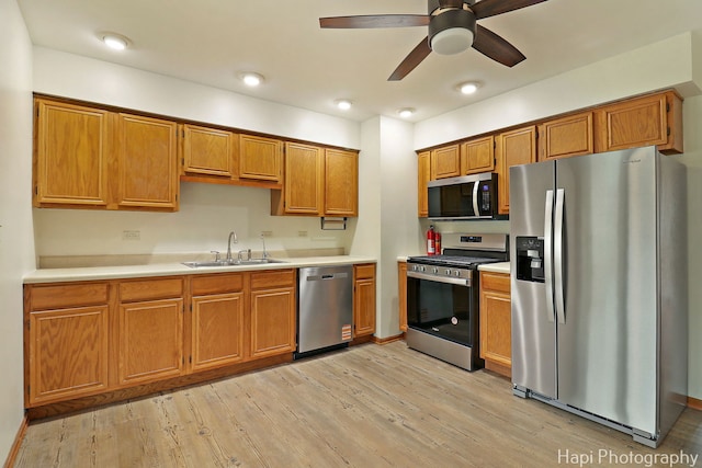 404 Rand Rd, Lakemoor, IL 60050 - kitchen featuring a sink, brown cabinetry, stainless steel appliances, and light wood-style flooring