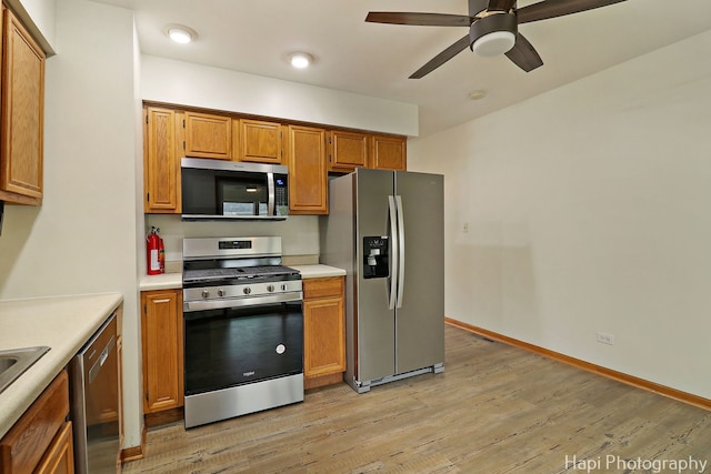 404 Rand Rd, Lakemoor, IL 60050 - kitchen with light wood-style floors, brown cabinetry, appliances with stainless steel finishes, and light countertops