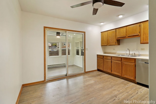 404 Rand Rd, Lakemoor, IL 60050 - kitchen with a sink, dishwasher, light countertops, brown cabinetry, and a ceiling fan