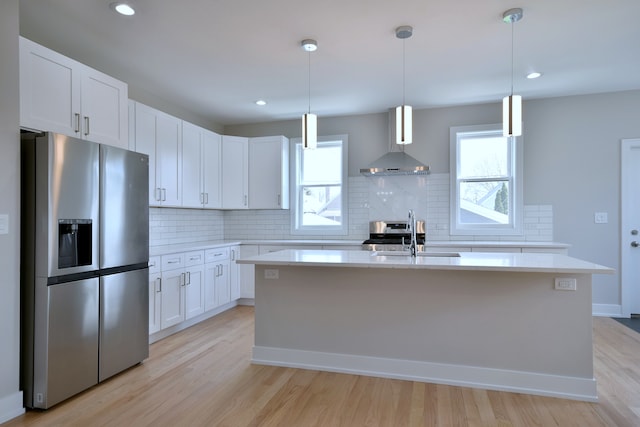 2123 N Austin Ave, Chicago, IL 60639 - kitchen featuring decorative backsplash, light countertops, wall chimney exhaust hood, a sink, and appliances with stainless steel finishes