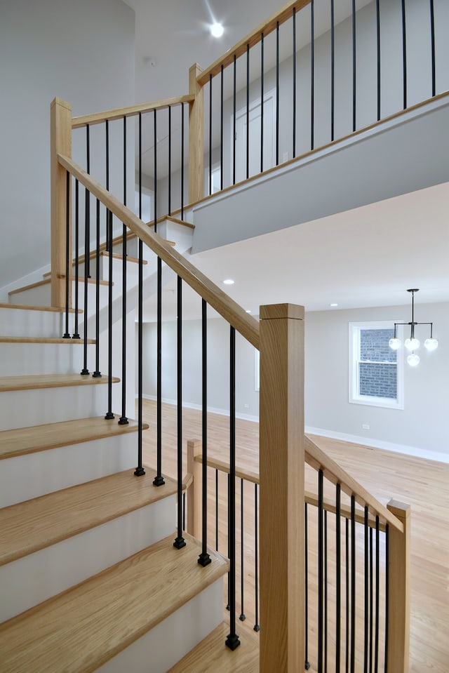 2123 N Austin Ave, Chicago, IL 60639 - staircase featuring a high ceiling, wood finished floors, and a notable chandelier