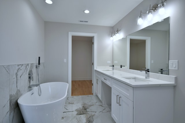 2123 N Austin Ave, Chicago, IL 60639 - full bathroom with a freestanding bath, a sink, marble finish floor, tile walls, and visible vents