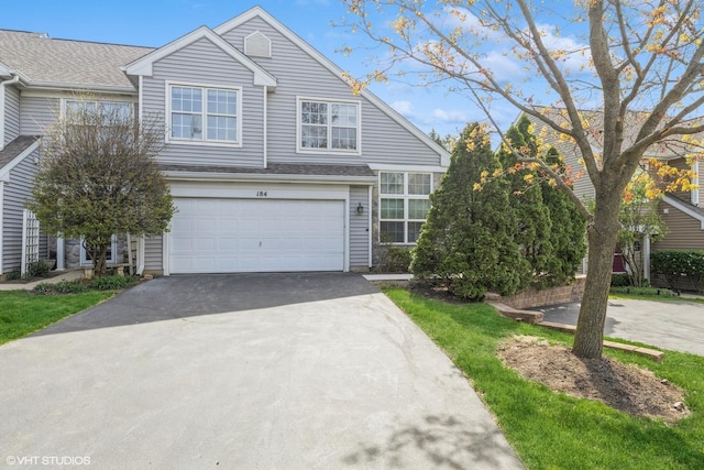 view of front of home with an attached garage and aphalt driveway