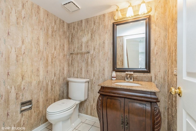bathroom featuring vanity, toilet, tile patterned floors, baseboards, and visible vents