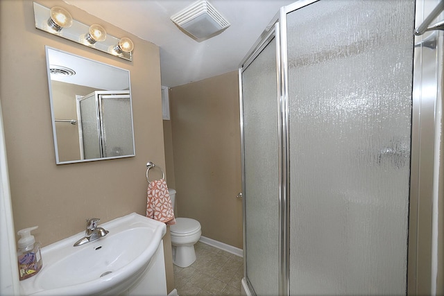 bathroom featuring visible vents, toilet, tile patterned floors, a shower stall, and a sink