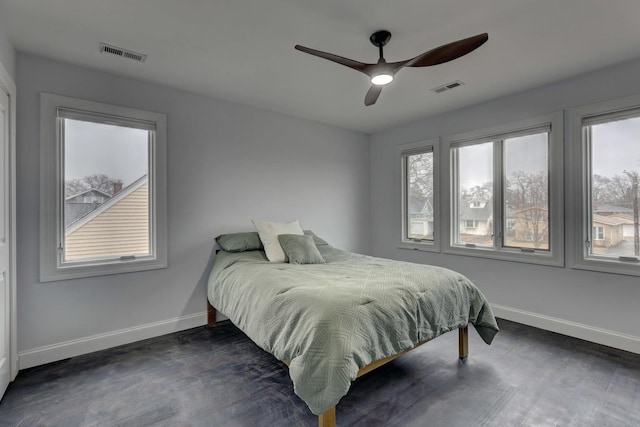 bedroom featuring visible vents, baseboards, and multiple windows