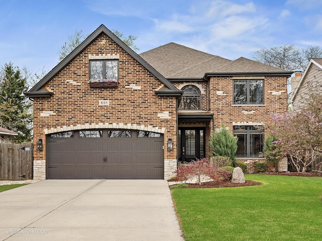 view of front facade with concrete driveway, brick siding, a front yard, and roof with shingles