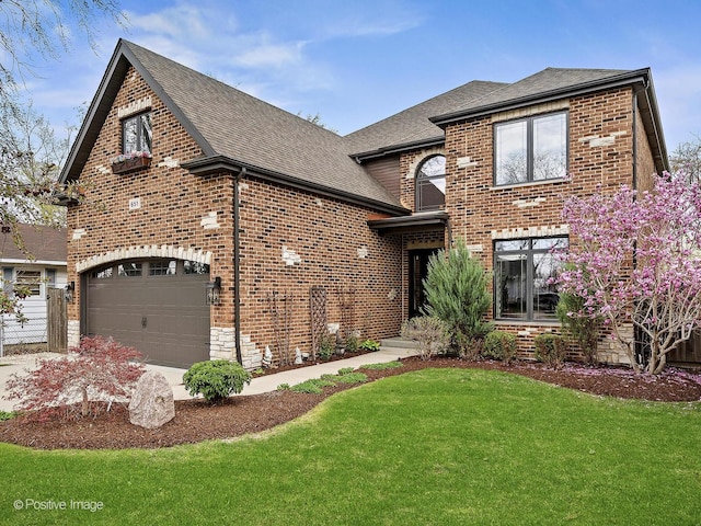 view of front of home with roof with shingles, a front lawn, brick siding, a garage, and concrete driveway