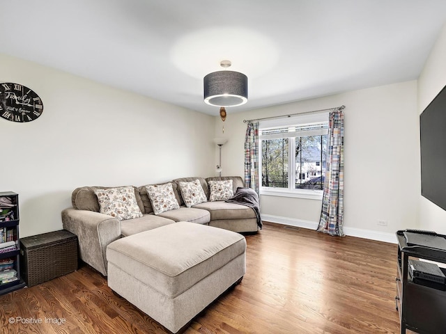 living room featuring baseboards and wood finished floors