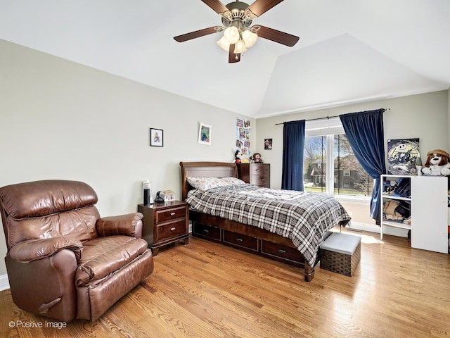 bedroom featuring high vaulted ceiling, ceiling fan, and light wood-type flooring