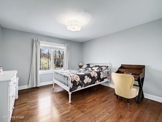 bedroom featuring baseboards and wood finished floors