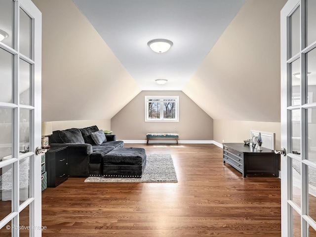 living area with baseboards, french doors, wood finished floors, and lofted ceiling