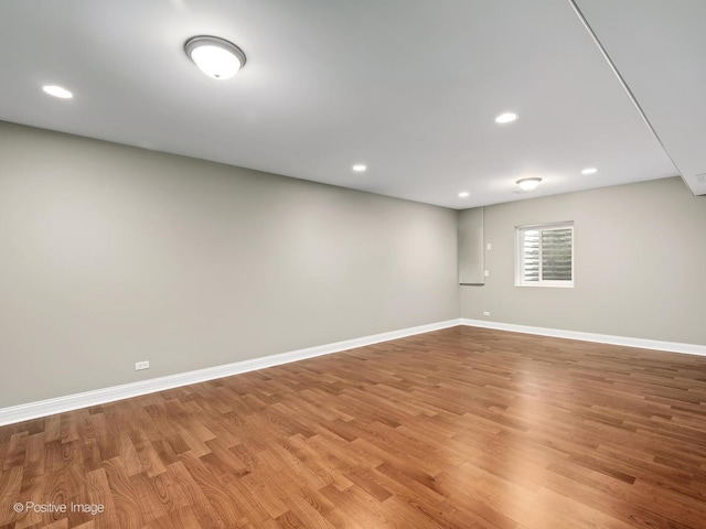 basement featuring baseboards, recessed lighting, and light wood finished floors