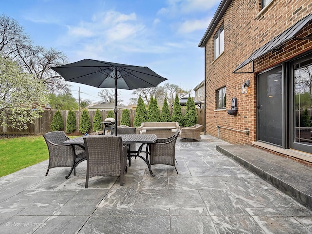 view of patio featuring a fenced backyard and outdoor dining area