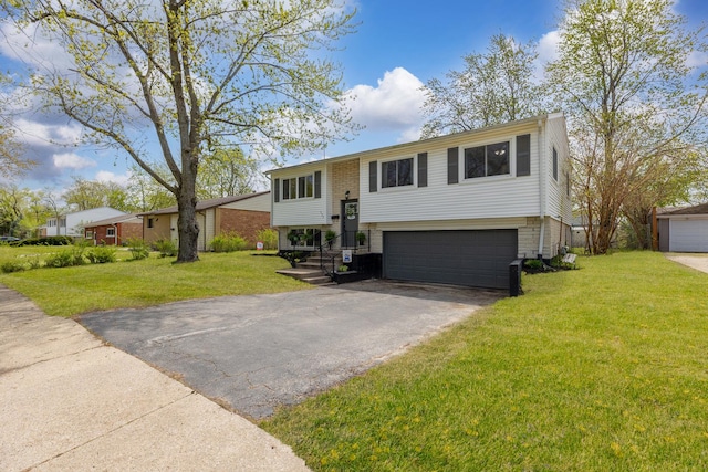 bi-level home featuring a garage, a front yard, and aphalt driveway