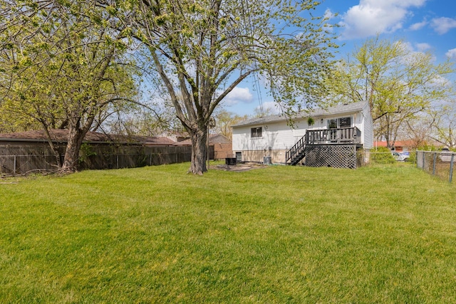 view of yard featuring a fenced backyard, a wooden deck, and stairway
