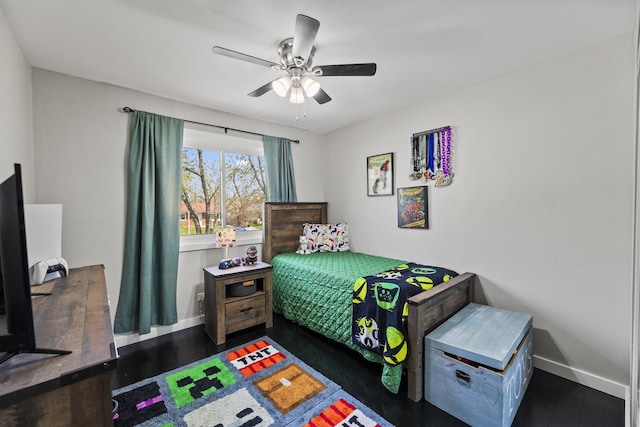 bedroom with baseboards, a ceiling fan, and wood finished floors