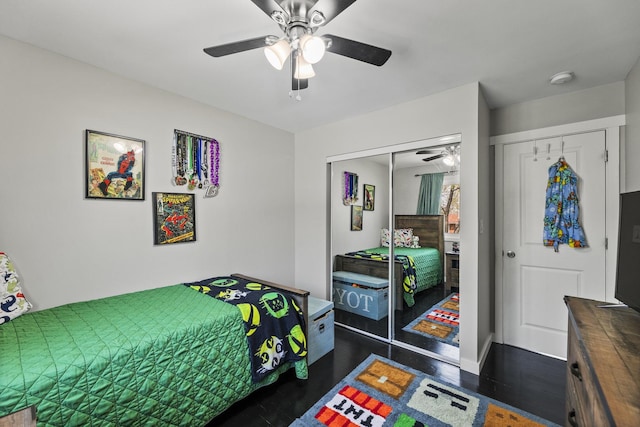 bedroom featuring a closet, dark wood-style flooring, and ceiling fan