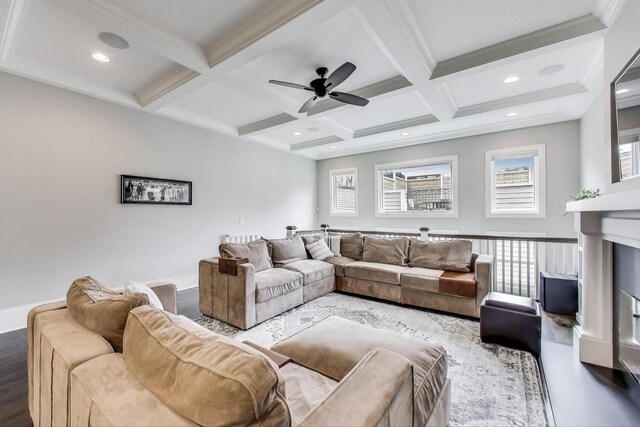 living room with wood finished floors, coffered ceiling, beamed ceiling, ceiling fan, and baseboards