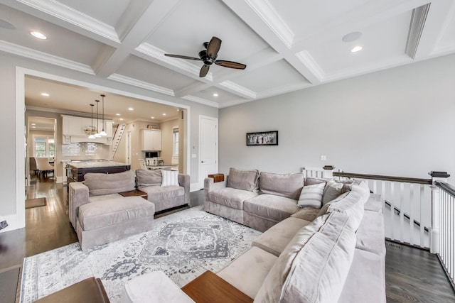 living area with dark wood finished floors, ornamental molding, recessed lighting, beamed ceiling, and ceiling fan