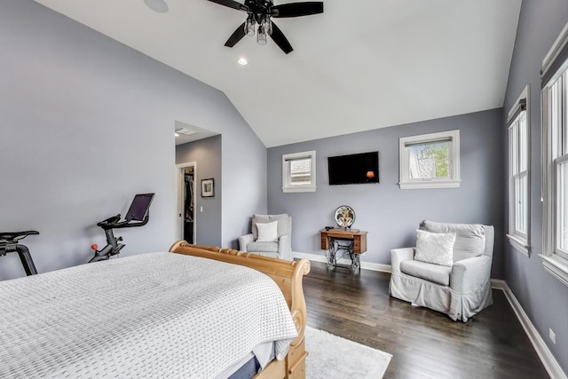 bedroom featuring lofted ceiling, multiple windows, dark wood-style floors, baseboards, and a ceiling fan