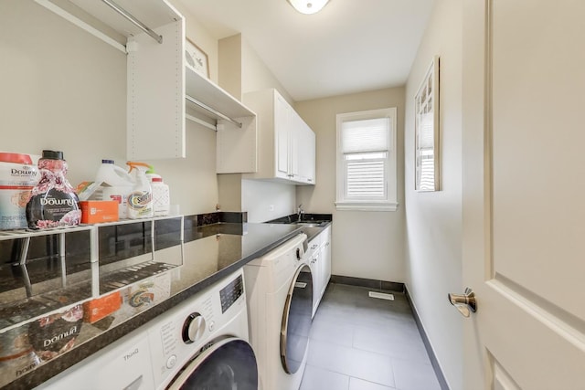 washroom featuring cabinet space, washer and dryer, baseboards, and tile patterned floors
