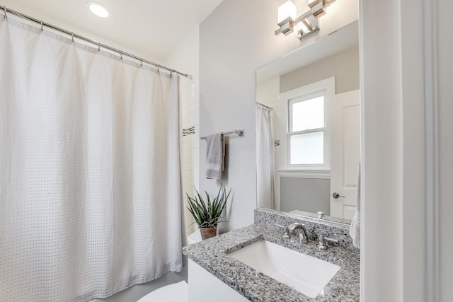 bathroom featuring toilet and vanity