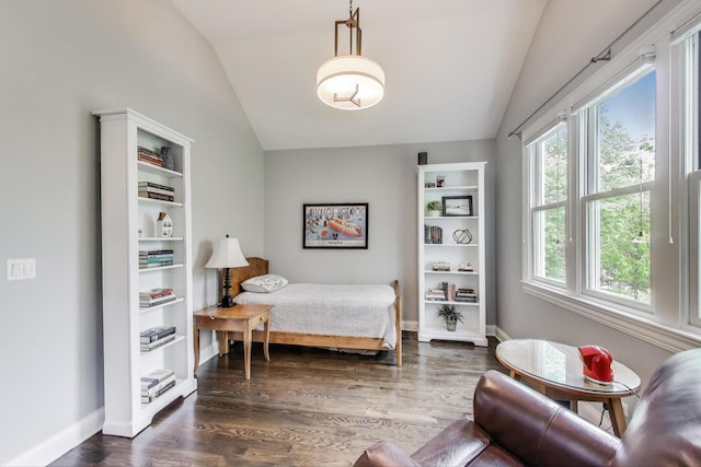 bedroom with lofted ceiling, dark wood-style flooring, and baseboards