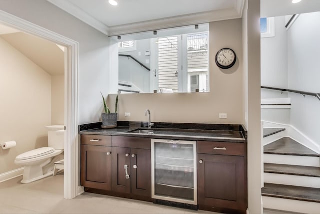 bar featuring wine cooler, a sink, stairway, ornamental molding, and baseboards