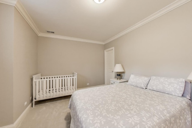 bedroom with carpet, ornamental molding, and baseboards