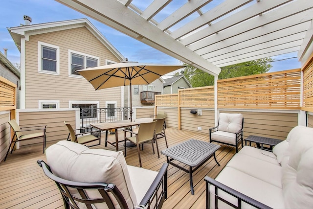 wooden deck with outdoor dining area, an outdoor hangout area, and a pergola
