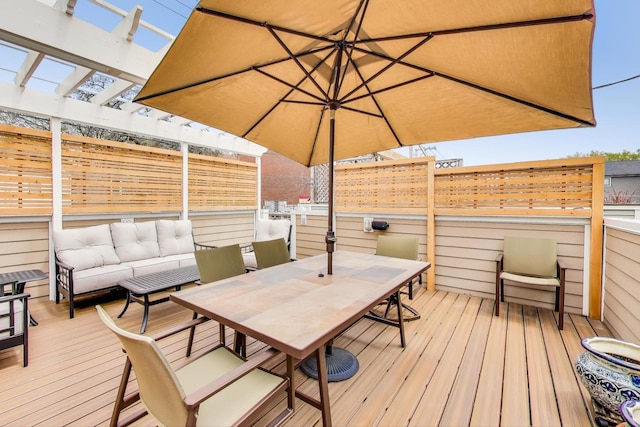 deck featuring fence, outdoor dining area, a pergola, and outdoor lounge area
