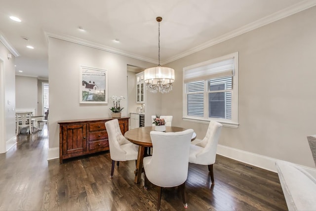 dining space with dark wood finished floors, a chandelier, crown molding, baseboards, and recessed lighting