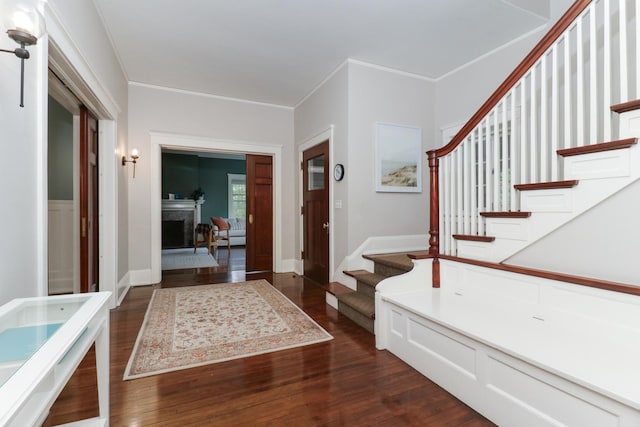 1314 E Washington St, Bloomington, IL 61701 - entrance foyer featuring stairway, crown molding, a fireplace, and dark wood-style floors