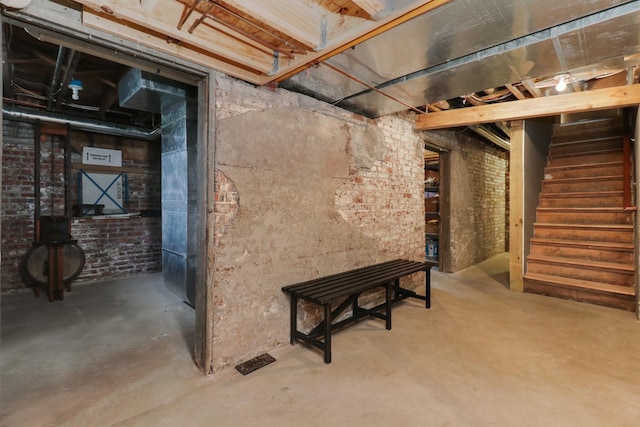 1314 E Washington St, Bloomington, IL 61701 - unfinished below grade area featuring stairs and brick wall