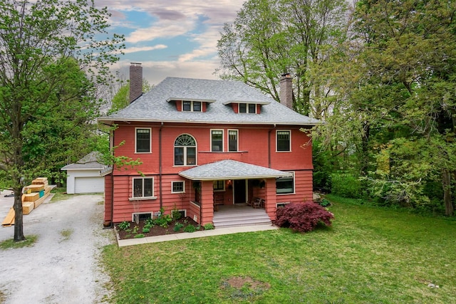 1314 E Washington St, Bloomington, IL 61701 - view of front facade featuring covered porch, a chimney, an outdoor structure, and a front lawn