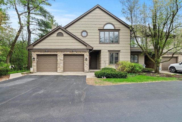 1105 Foxtail Ct Unit 1105, Darien, IL 60561 - traditional-style house with an attached garage, driveway, and stone siding