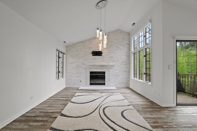 1105 Foxtail Ct Unit 1105, Darien, IL 60561 - unfurnished living room with baseboards, a glass covered fireplace, wood finished floors, and high vaulted ceiling