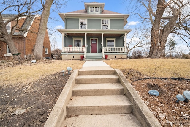 american foursquare style home featuring a porch