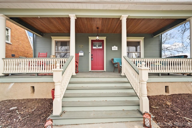 view of exterior entry featuring a porch