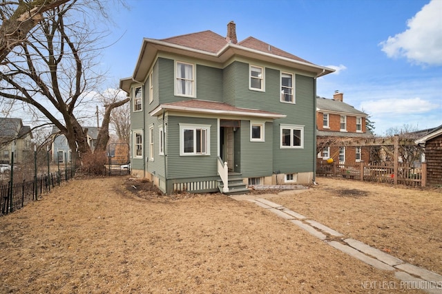 view of front of property with entry steps, fence, a chimney, and roof with shingles