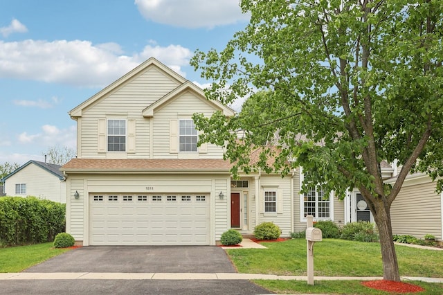 1011 Blackburn Dr, Grayslake, IL 60030 - traditional-style home with driveway, a front lawn, and a garage